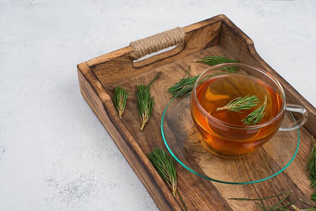 Free Photo pine needle tea in a cup on a white textured background empty copy space for text hot drink