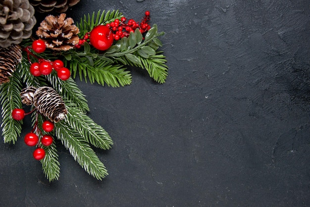 Pine nuts with red decorations as a christmas concept on gray background