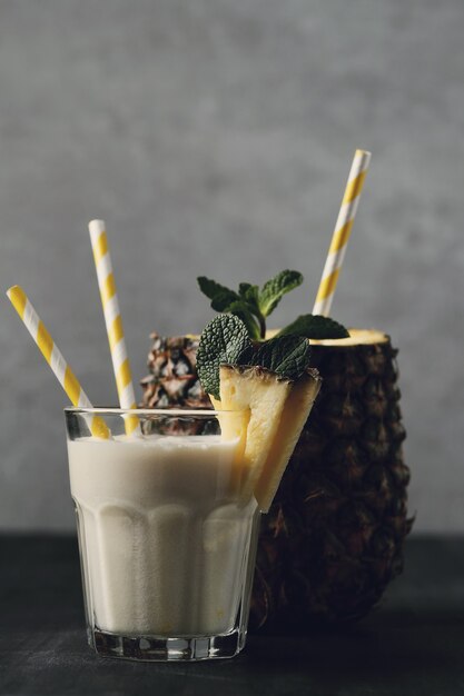 Pineapple cocktail with straw. Tropical drink