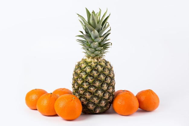 Free Photo pineapple tangerines fresh ripe mellow juicy whole tasty fruits on a white