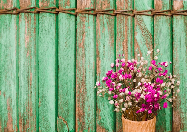 Free photo pink baby's-breath flowers against wooden shutters background