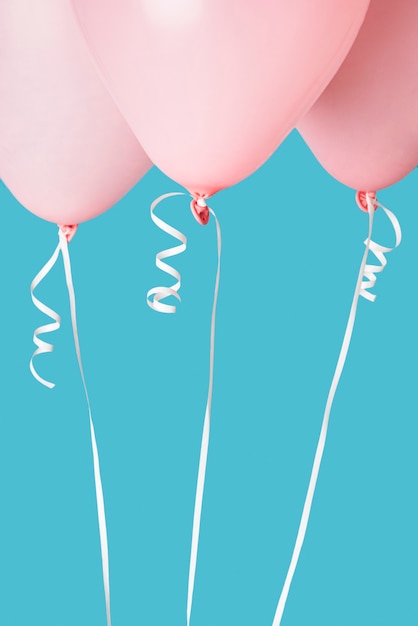 Free Photo pink balloons on blue background