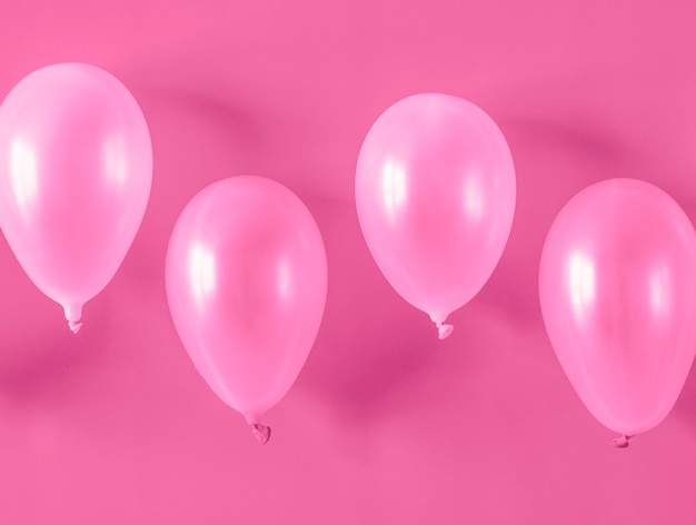 Pink balloons on pink background