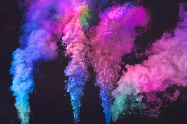 Free Photo pink and blue smoke effect on a black wallpaper