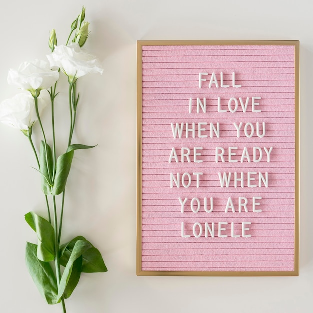 Free photo pink board with text and flowers