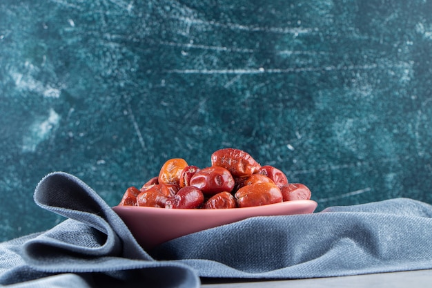 Free photo pink bowl of tasty ripe silverberries on marble background.