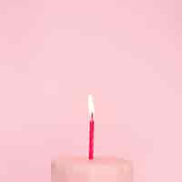 Free photo pink cake with lit candle