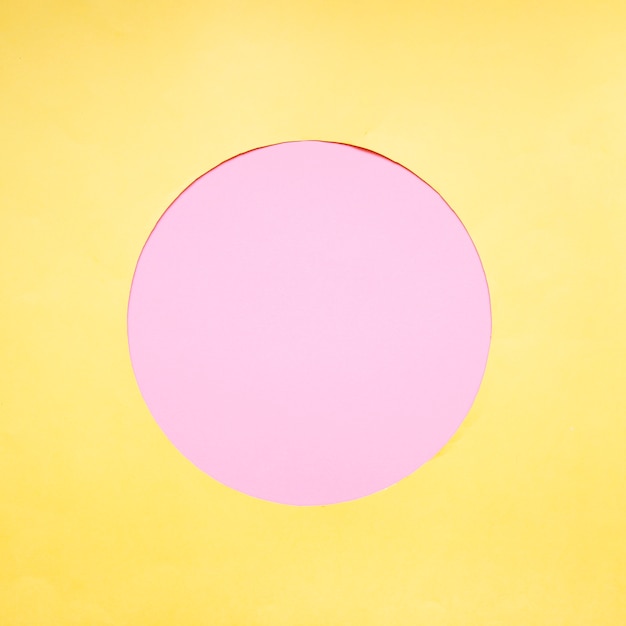 Free photo pink circle on yellow background