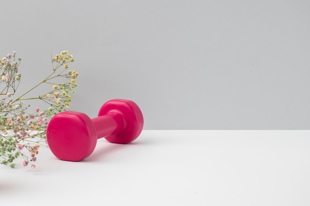 Free Photo pink dumbbell and flowers arrangement