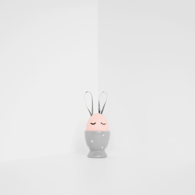 Free Photo pink easter egg in gray holder