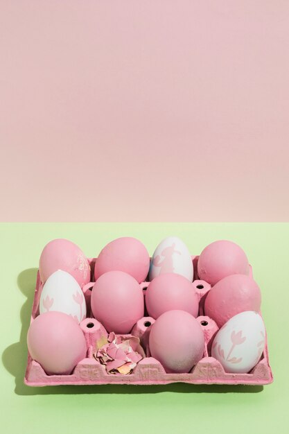 Pink Easter eggs in big rack on table