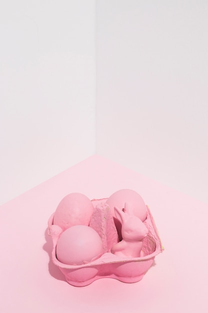 Free photo pink easter eggs with small rabbit in rack