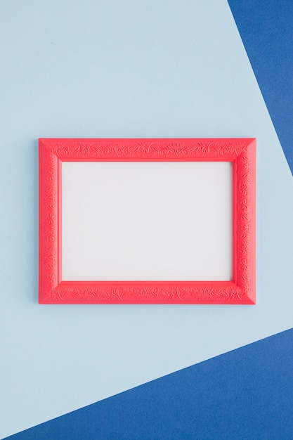 Free Photo pink empty frame on blue background