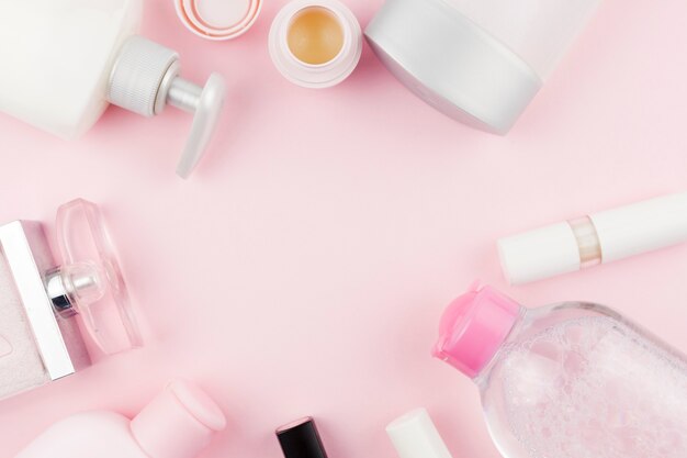 Pink face care products creating round frame