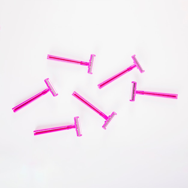 Free Photo pink female razors on white background