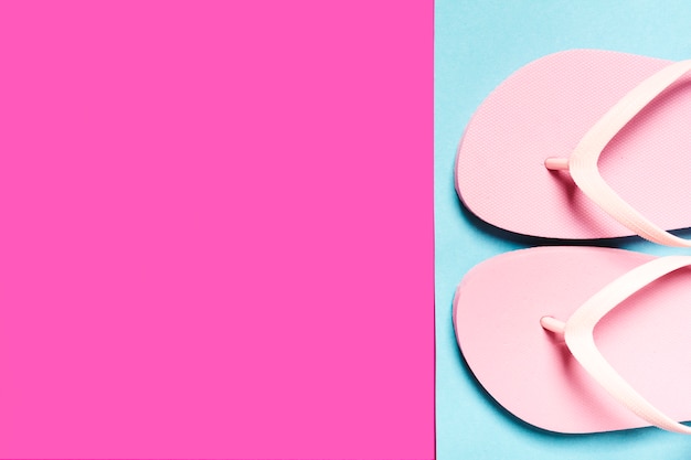 Free Photo pink flip-flops on colorful surface