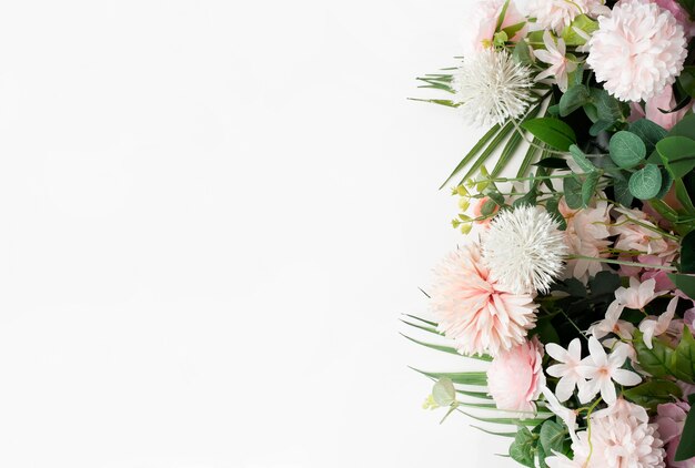 Pink flower border with palm leaves on white background