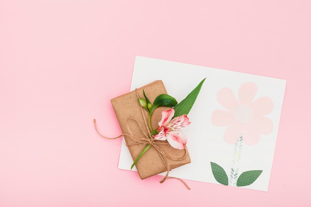 Pink flower with gift box on pink table