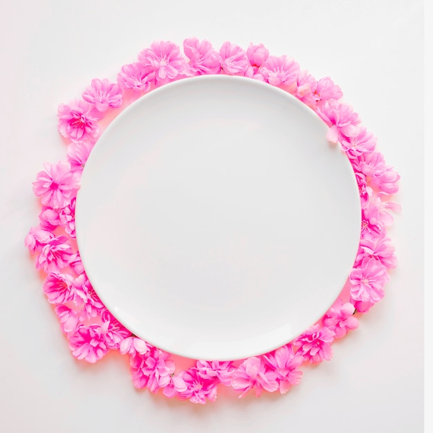 Pink flowers around plate