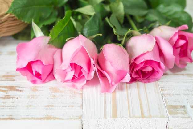 Free photo pink fresh rose over white wooden background