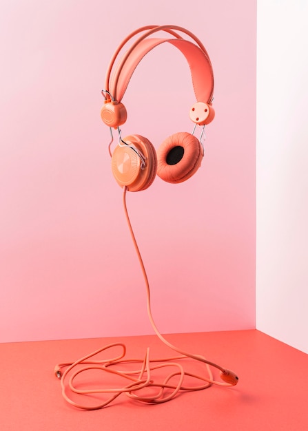 Free Photo pink headphones with cable flying