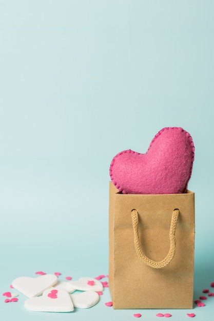 Pink heart in craft bag near decorations