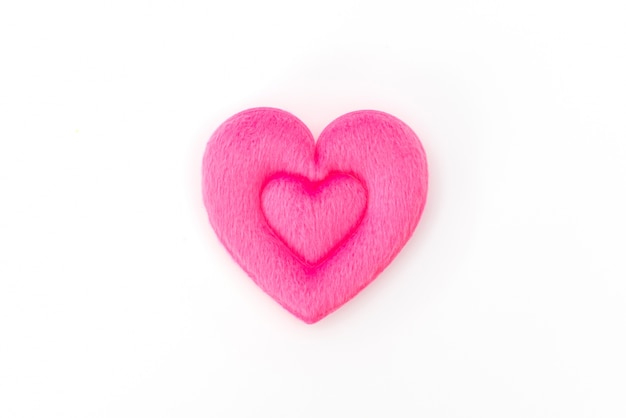 Free Photo pink heart pillow on white background .