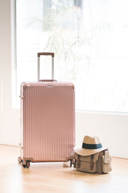 Free Photo pink luggage and bag and hat for travel