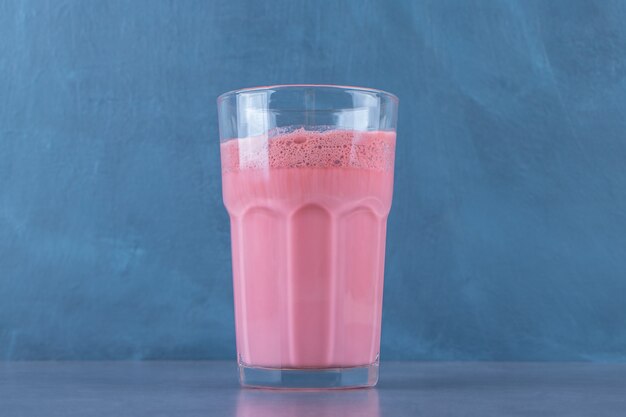 Pink mocha latte with milk in a glass, on the marble table