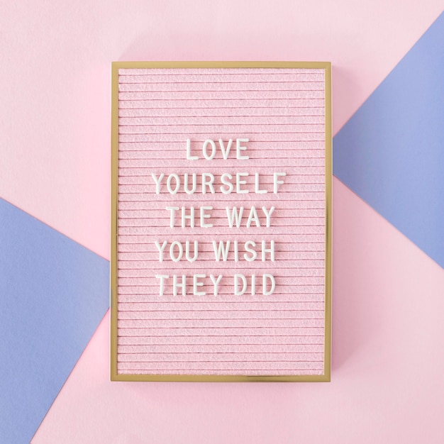 Free photo pink motivational text board flat lay