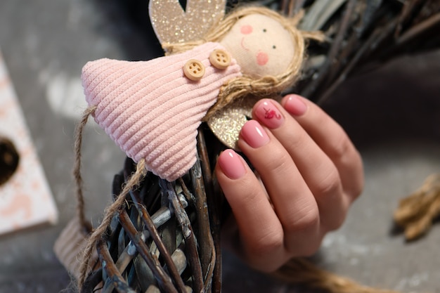 Pink nail design. Female hand with pink manicure.