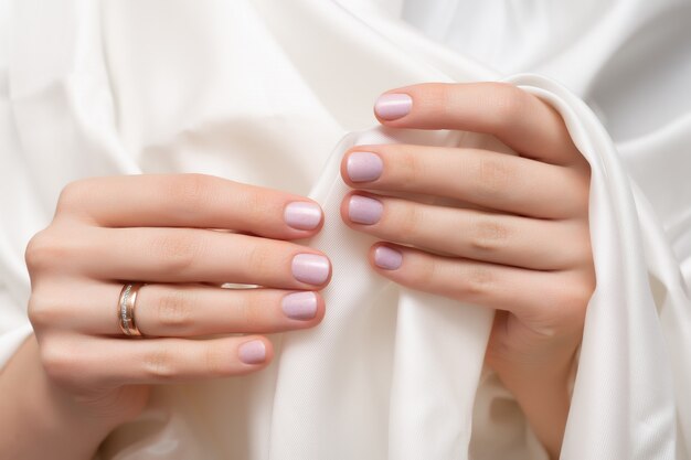 Pink nail design. Female hands with glitter manicure.