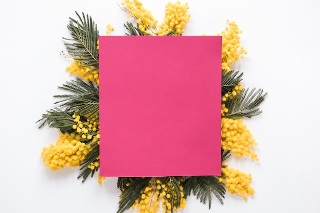 Pink paper on yellow flower branches