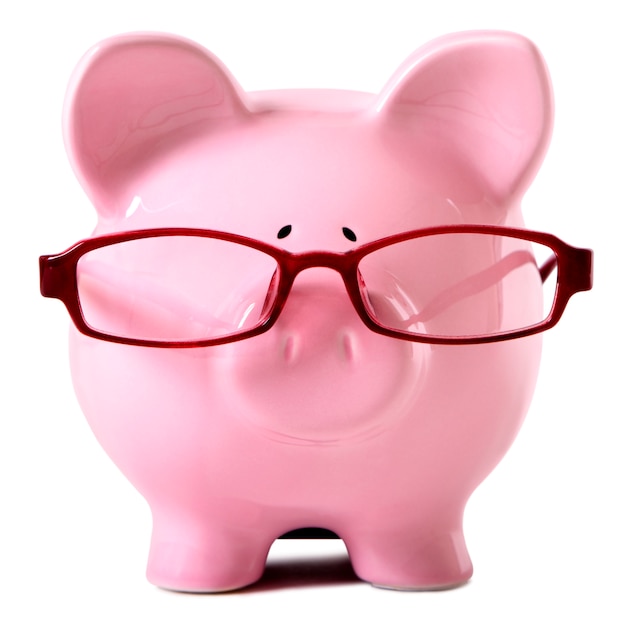 Pink piggy bank wearing glasses isolated white