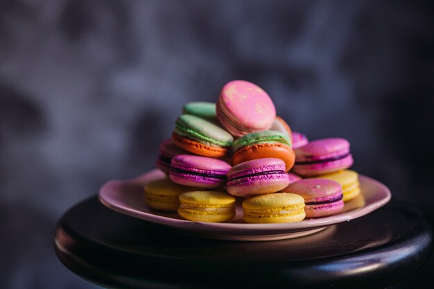 Pink plate with delicious colorful macaroons 