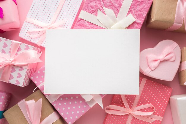 Pink presents with blank paper on top