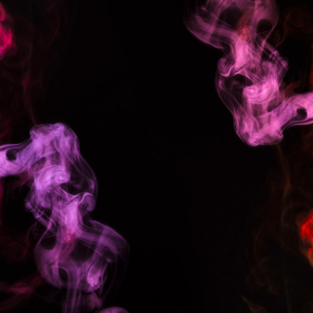 Pink and purple smoke on the corner of the black background