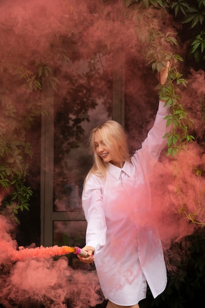 Free photo pink smoke background with young adult