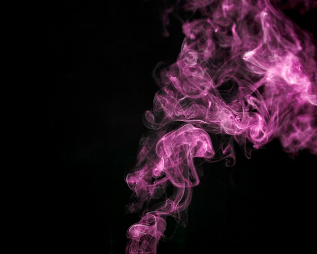 Free photo pink smoke on black background