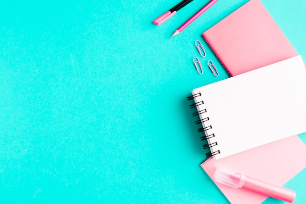 Free photo pink stationery on colored surface