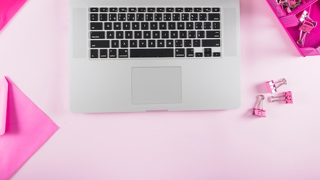 Pink stationery near laptop keyboard