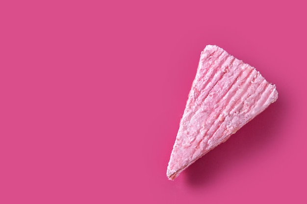 Pink strawberry cake portion on pink background