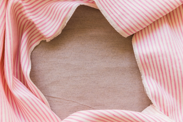 Pink and white stripes fabric material on plain sack cloth