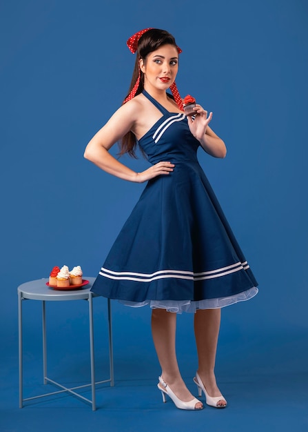 Pinup girl posing next to a table