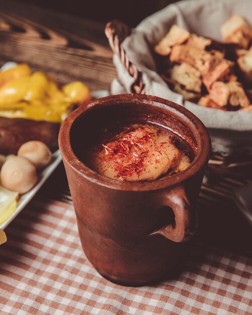 Pitie in a clay pot and a basket of bread