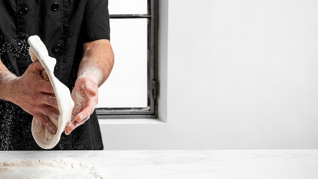 Pizza chef making pizza dough with copy-space