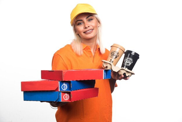 Free photo pizza delivery woman holding pizza and coffees on white background. high quality photo