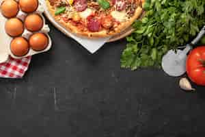 Free photo pizza dough and ingredients with copy-space