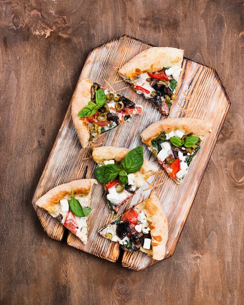 Pizza slices on cutting board above view