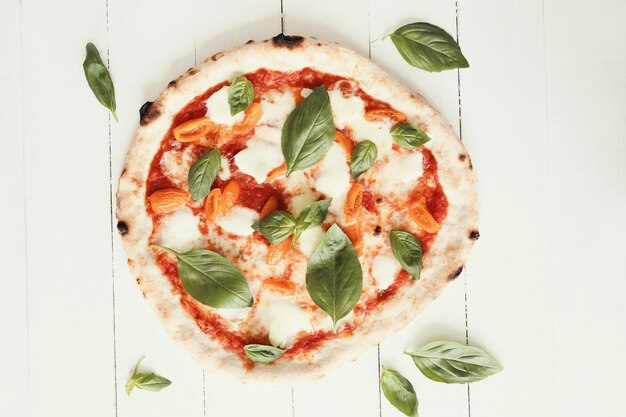 Pizza on white wooden table